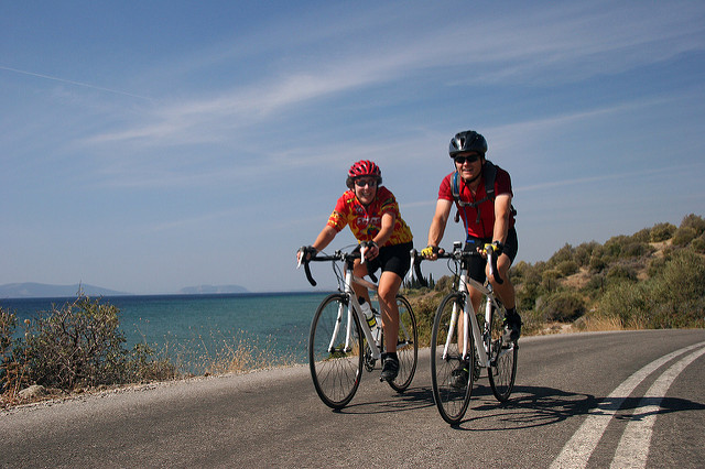 A woman and a man cycling during activity holidays in Greece.