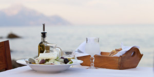 Enjoying a traditional Greek dinner by the sea.